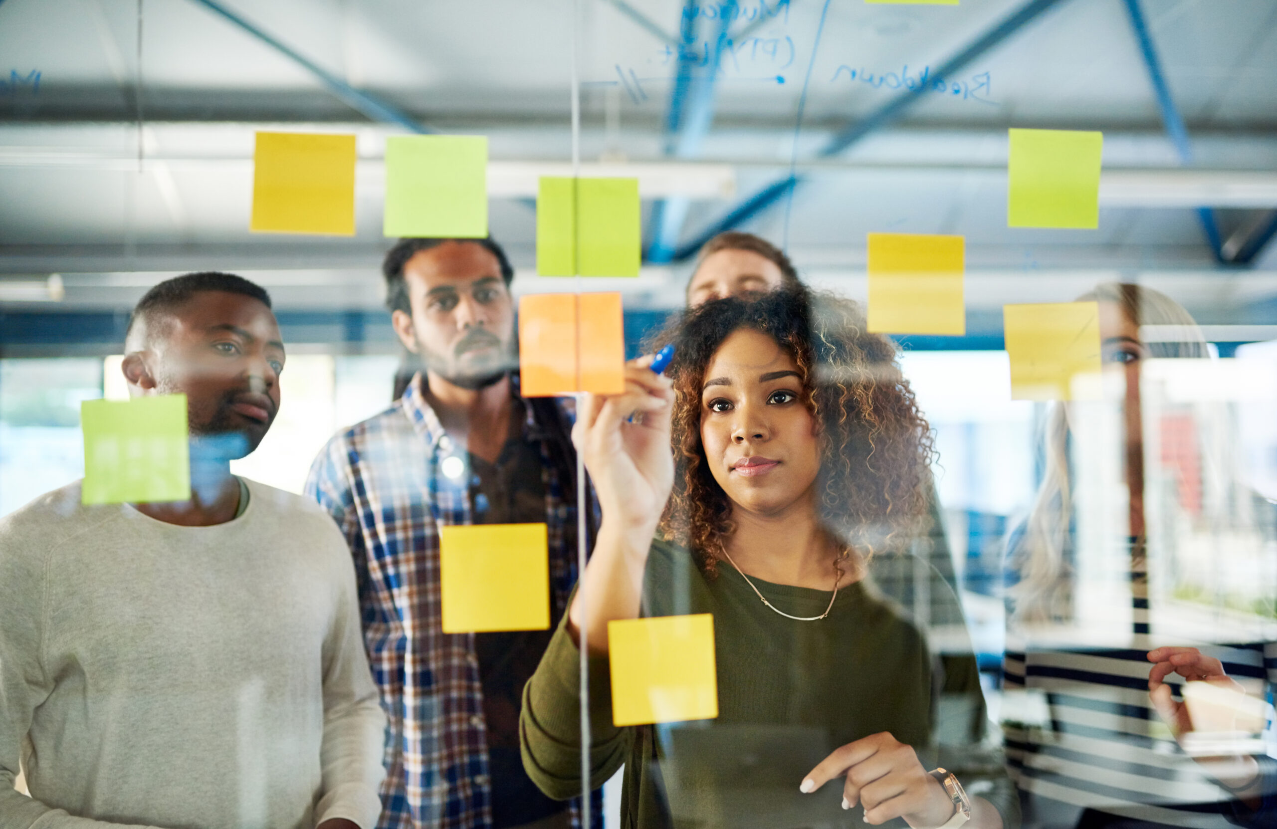 Diverse business people strategizing with sticky notes