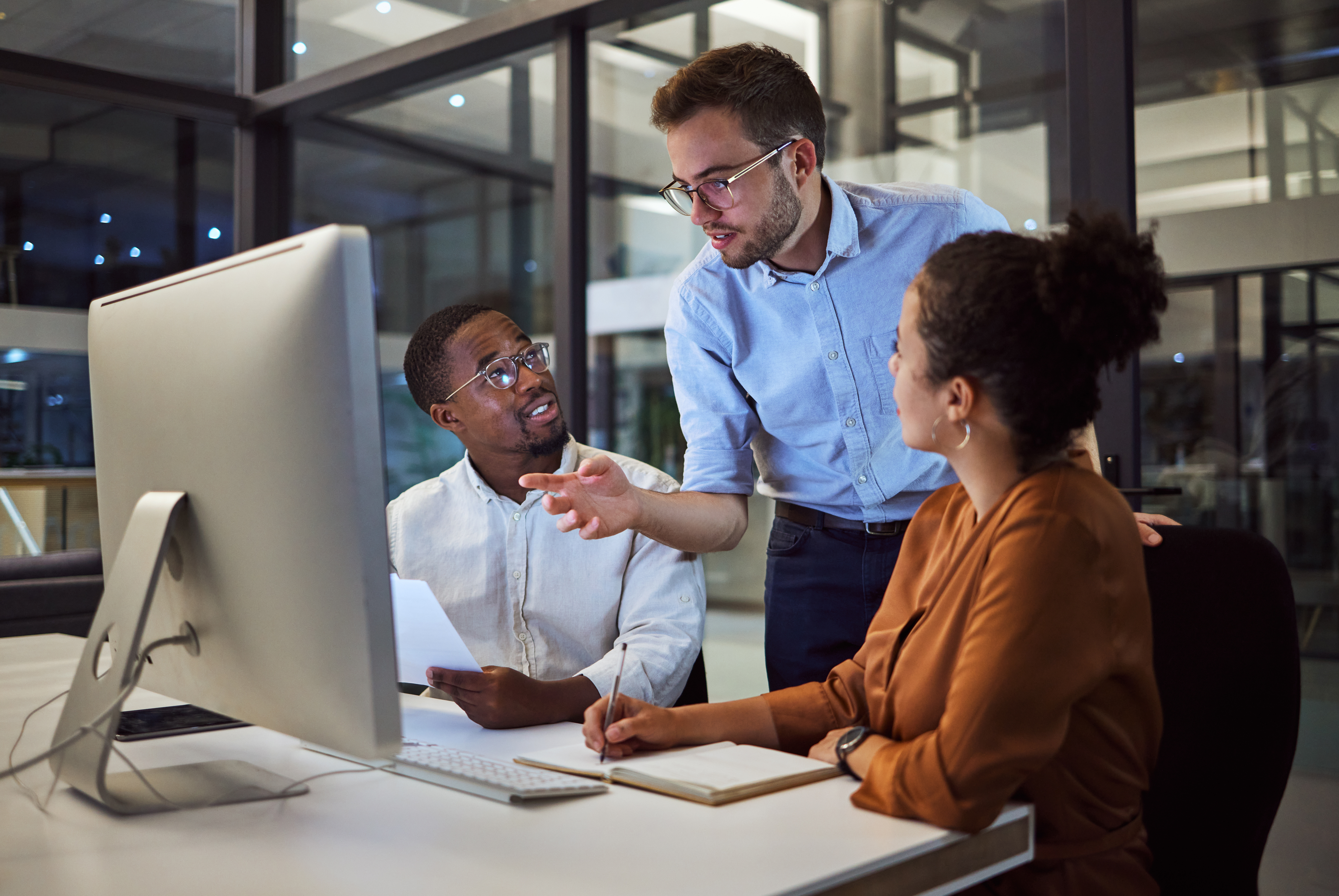 Diverse business people looking at computer